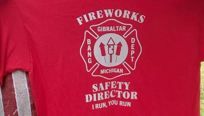 Red shirt printed with a fire department crest and text reading "Fireworks Safety Director - I Run, You Run."
