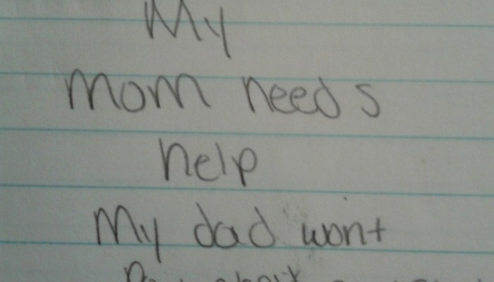 Handwritten note on lined paper reading, "My mom needs help My dad wont".