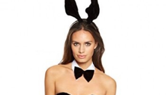 Woman wearing black bunny ears, a white collar, and a black bowtie.