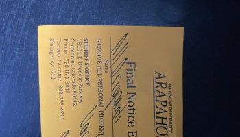 A yellow final eviction notice from the Arapahoe County Sheriff's Office.