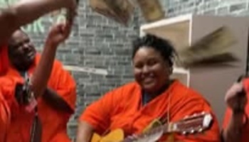 Joyful musicians in matching bright orange outfits playing acoustic guitar and percussion.