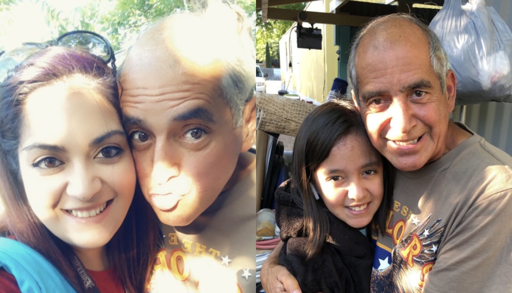 An older man poses playfully with a young woman on the left and hugs a smiling young girl on the right.