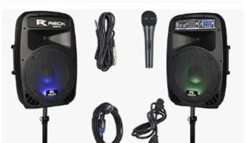 Two black PA speakers on stands with glowing LED lights, a handheld microphone, and coiled audio cables.