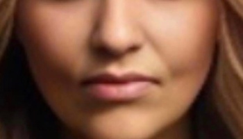 Close-up of a woman's lower face showing her nose, lips, and chin framed by light brown hair.