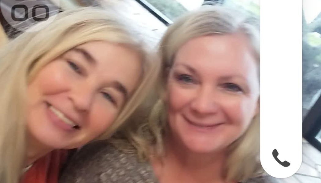 Two women with blonde hair smiling warmly together in a close-up selfie.