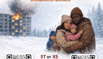 Family in winter coats hugging in snow as an apartment building burns behind them.