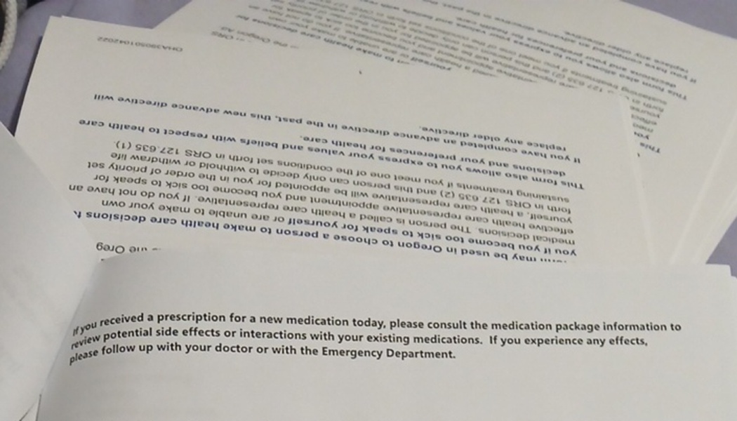 Stacked healthcare paperwork detailing Oregon advance directives and prescription medication instructions.