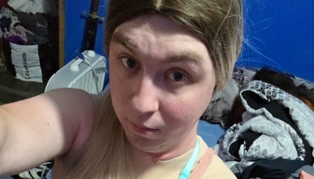 Close-up selfie of a person with long blonde hair looking directly into the camera.