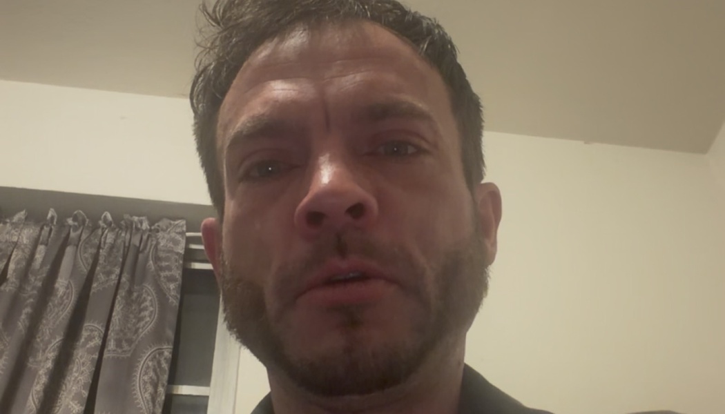 Close-up portrait of an emotional man with facial hair looking directly into the camera.