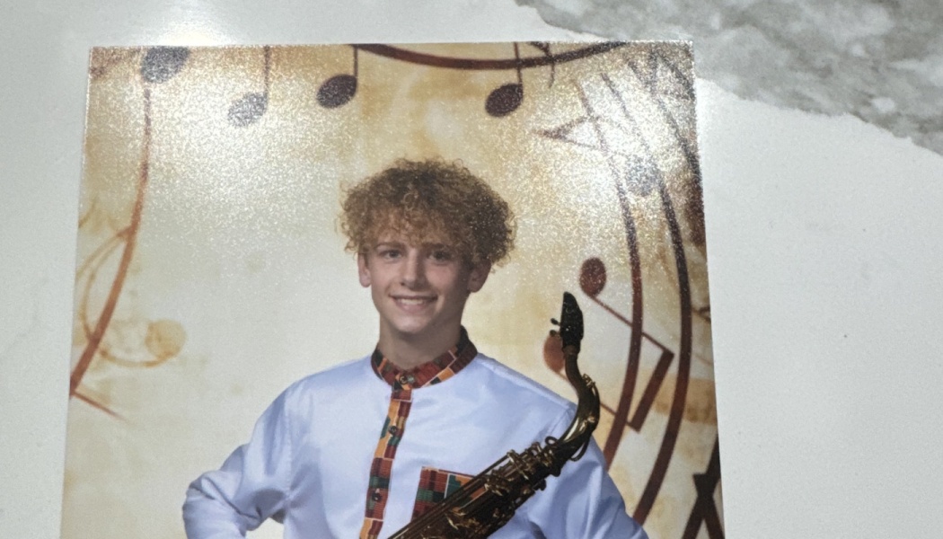 A smiling young musician with curly hair holds a saxophone against a musical note background.