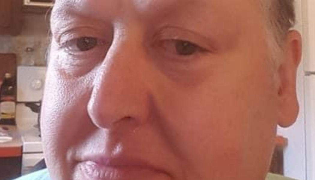 Close-up portrait of a person looking directly at the camera with a calm expression.