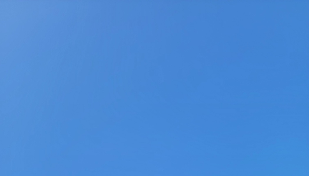 A clear, cloudless bright blue sky.
