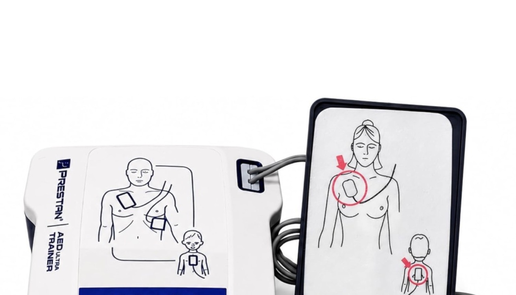 Prestan AED UltraTrainer device and connected training pads featuring illustrated electrode placement diagrams.