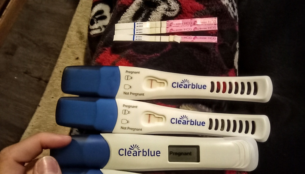 Multiple positive pregnancy tests, including a digital Clearblue test reading Pregnant.
