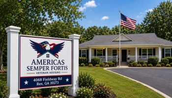 Sign for Americas Semper Fortis Veteran Housing in front of a single-story home with an American flag.