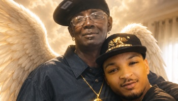 Two Black men in baseball caps embrace, framed by large white angel wings and a glowing heavenly background.