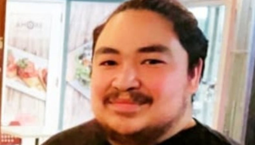 A smiling man with dark hair, a mustache, and beard looking directly at the camera.