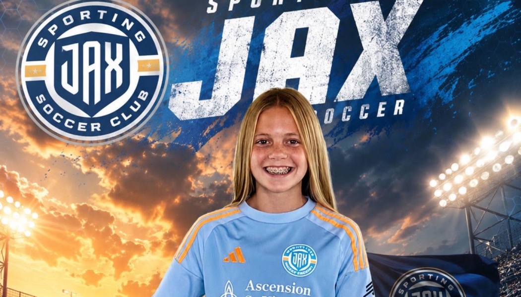 A smiling young soccer player with braces wearing a light blue Sporting JAX jersey in front of team graphics.