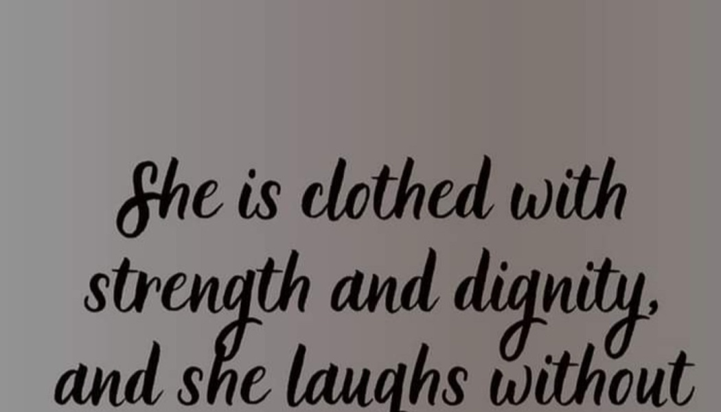 Cursive text reading: "She is clothed with strength and dignity, and she laughs without"
