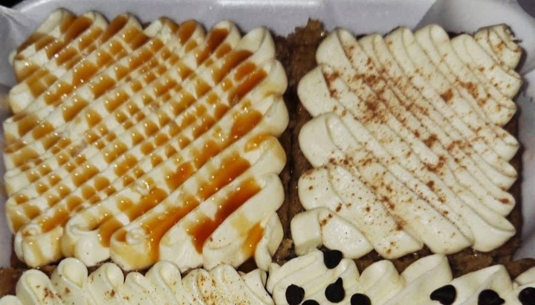Assorted cake squares topped with piped buttercream, caramel drizzle, cinnamon, and chocolate chips.