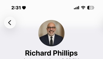Profile view for Richard Phillips, featuring a circular headshot of a smiling man in a suit and glasses.