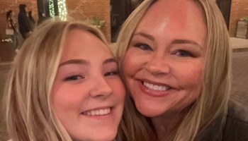 Two blonde women smiling brightly as they pose cheek-to-cheek for a close-up selfie.