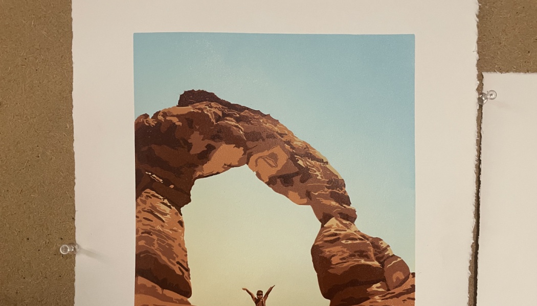 Art print of a person standing with arms raised beneath a towering red rock natural arch.
