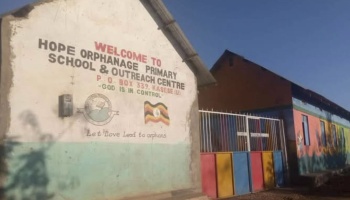 Hope Orphanage Primary School & Outreach Centre building and colorful gate in Kasese, Uganda.