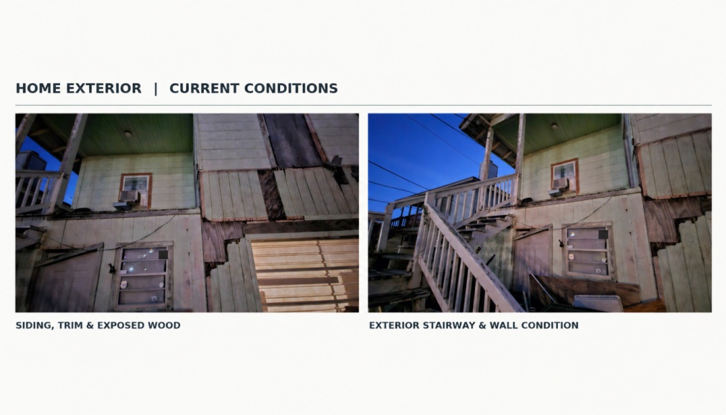 Damaged house exterior featuring missing wall panels, exposed wood, and a weathered wooden staircase.