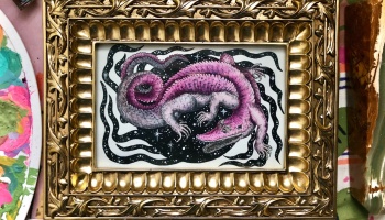 An ornate gold frame displaying a pink cosmic alligator illustration against a starry backdrop.