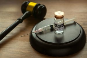 gavel syringe covid vaccine law
