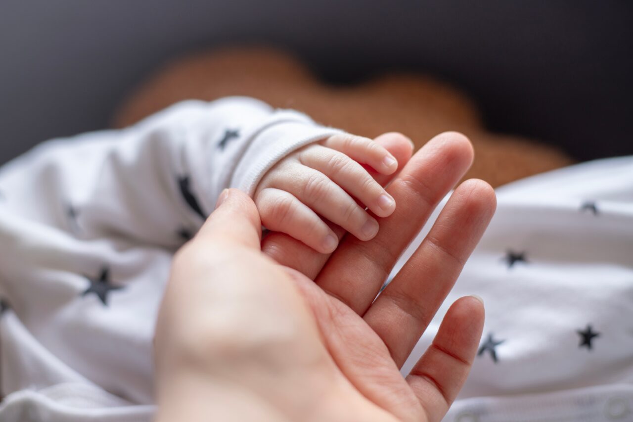 Newborn hands and holding fingers with parent ACIP HepB Meeting