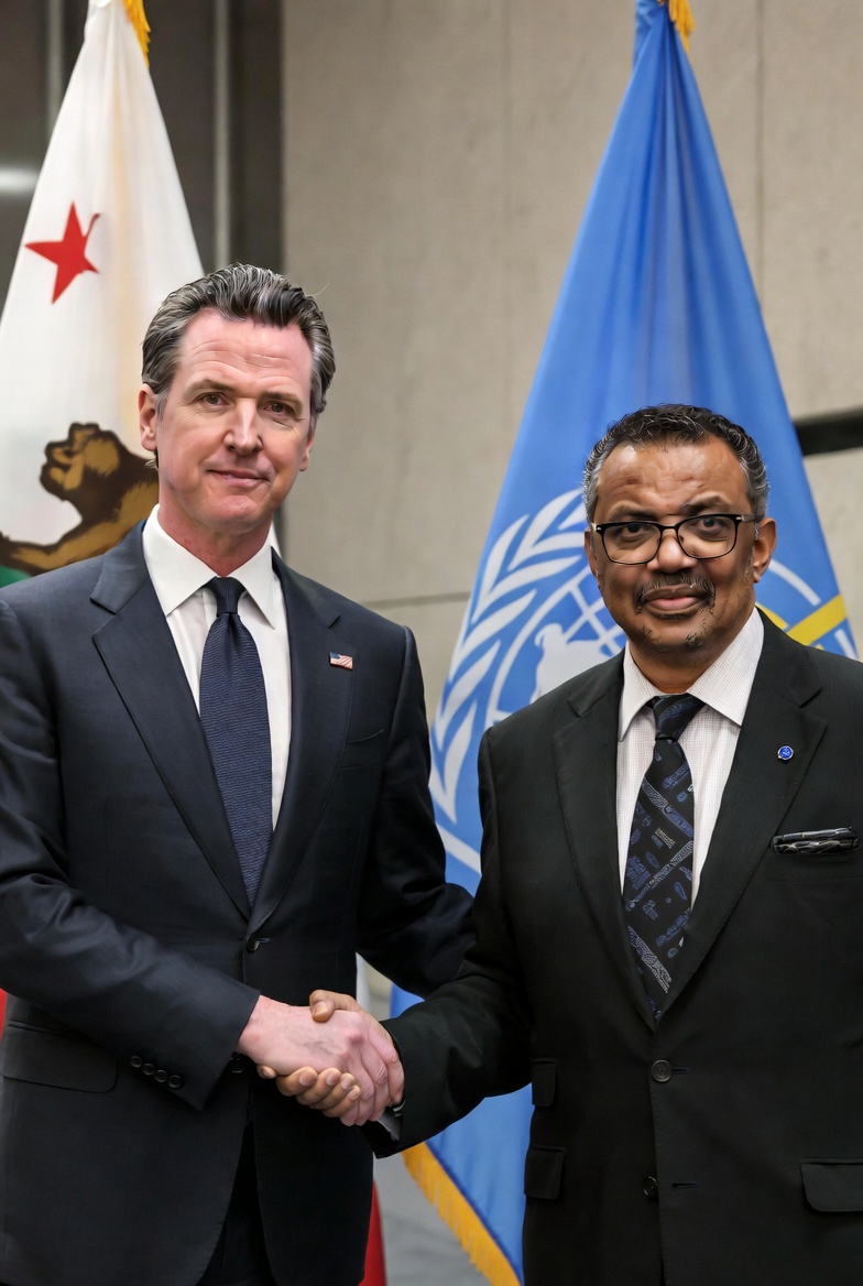 Newsom and Tedros holding hands making GOARN deal with CA and the WHO