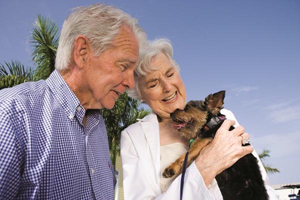 A couple with their dog at our senior living facility in Keller.