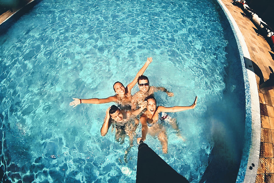 Resident friends playing in the pool at 4000 Hulen Urban Apartment Homes