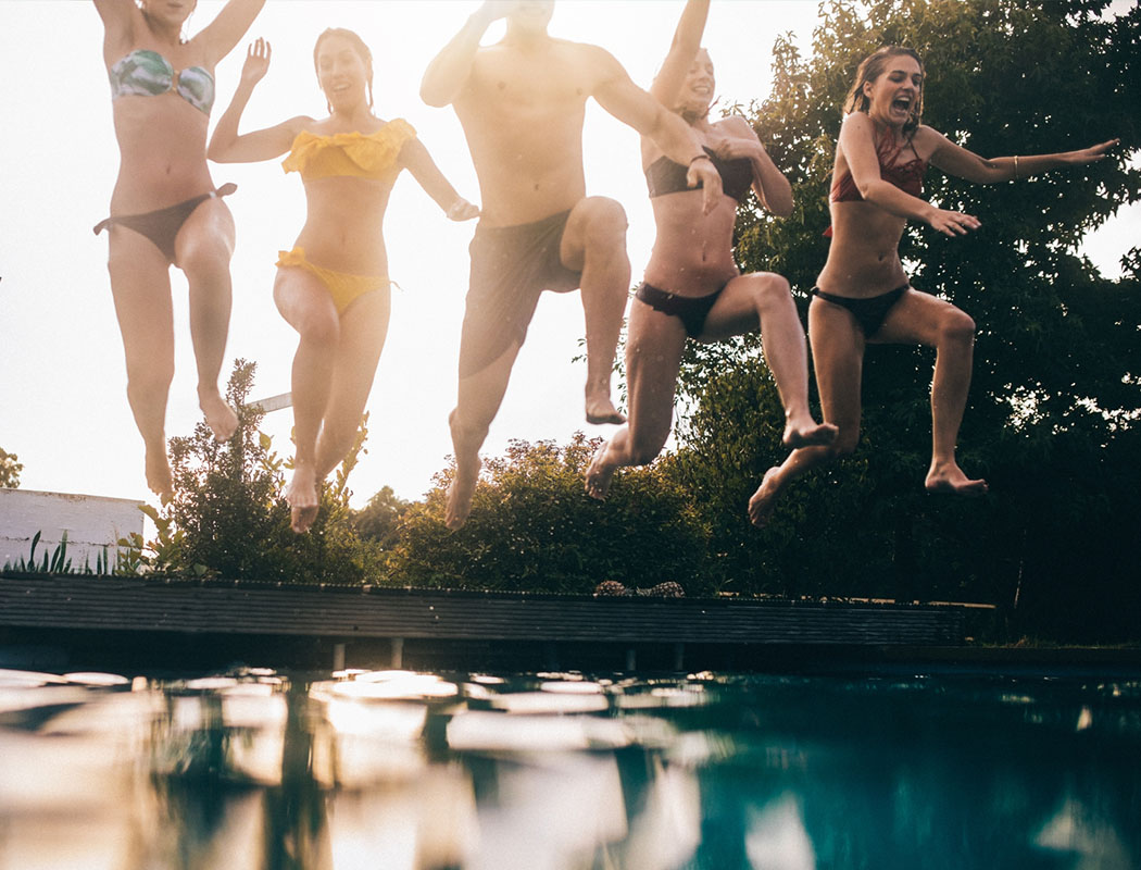 People jumping into the pool at K Avenue Station in Plano