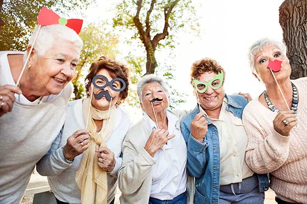 Seniors being silly at Osmond Senior Living Memory Care in Salt Lake.