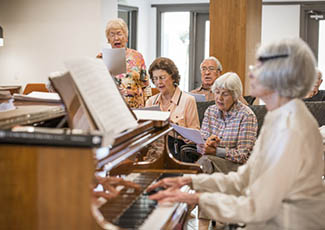 Resident playing piano at senior living in San Diego