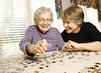 Woman doing a puzzle at Storey Oaks of Tulsa in Tulsa