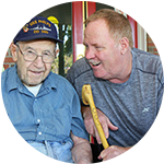 Caretaker having a conversation with a senior living resident at Carriage Court of Hilliard