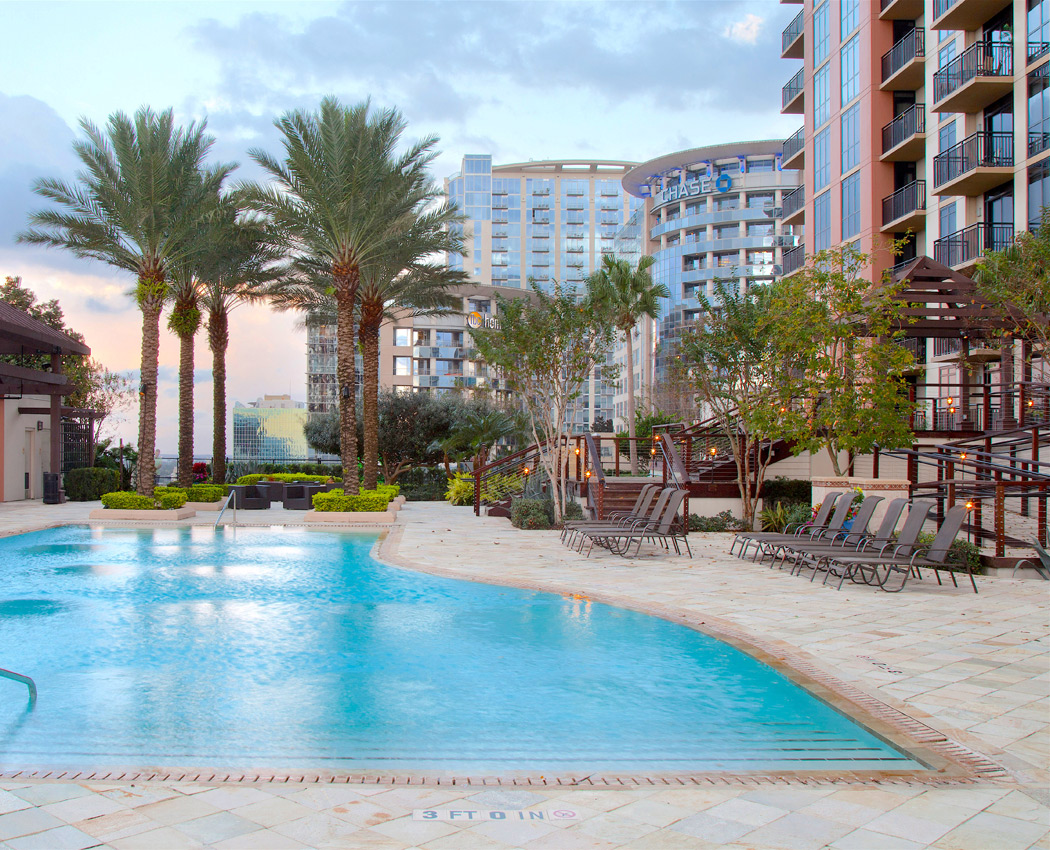 View of the 55 West Apartments swimming pool on a beautiful day