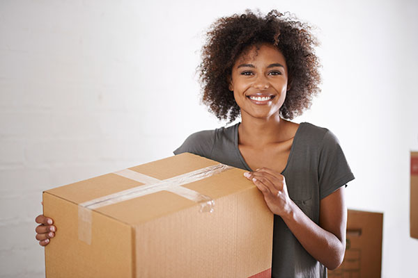 Woman packs a box for storage at ClimaSafe Self Storage