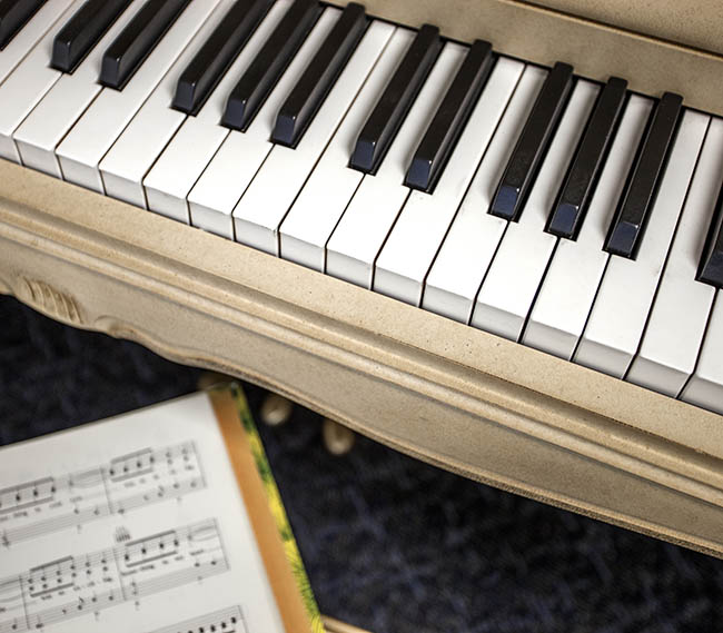Piano with sheet music at our senior apartments in Ventura