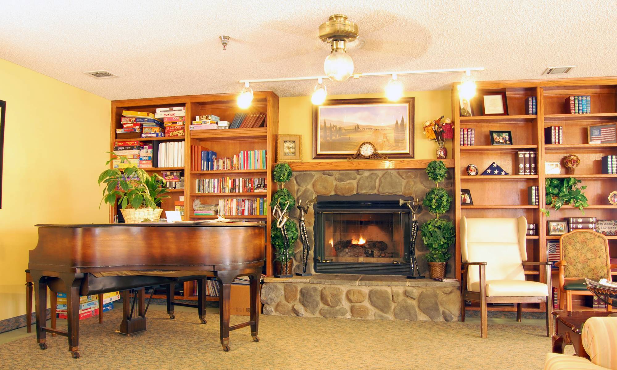 Beautiful living room with a piano at Sierra Vista Independent and Assisted Living