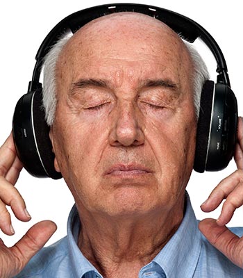 Memory care resident listens to music at Pacifica Senior Living