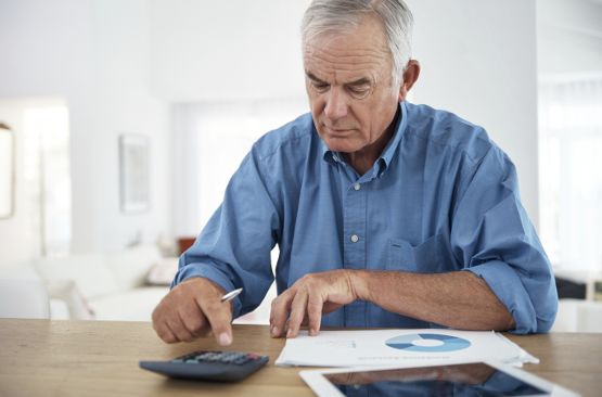 Senior living resident working on financial planning at Pacifica Senior Living