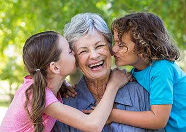 Grandmother with two grandchildren at Pacifica Senior Living Forest Trace