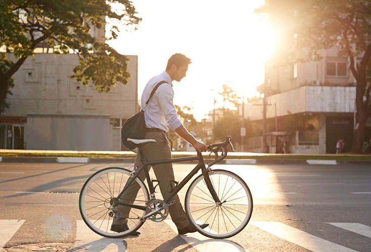 Man walking bike in Boston