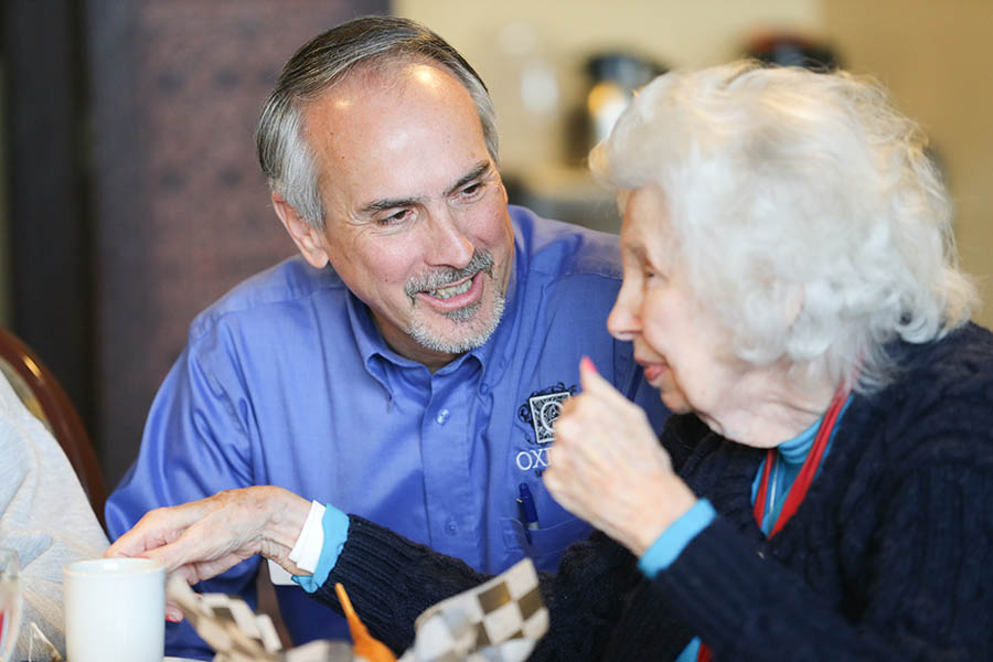 Happy resident and team member at Oxford Senior Living
