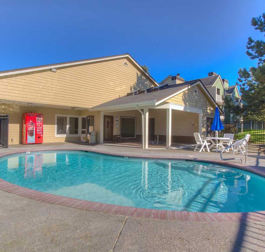 View of the swimming pool at Hamptons Apartments in Puyallup, Washington